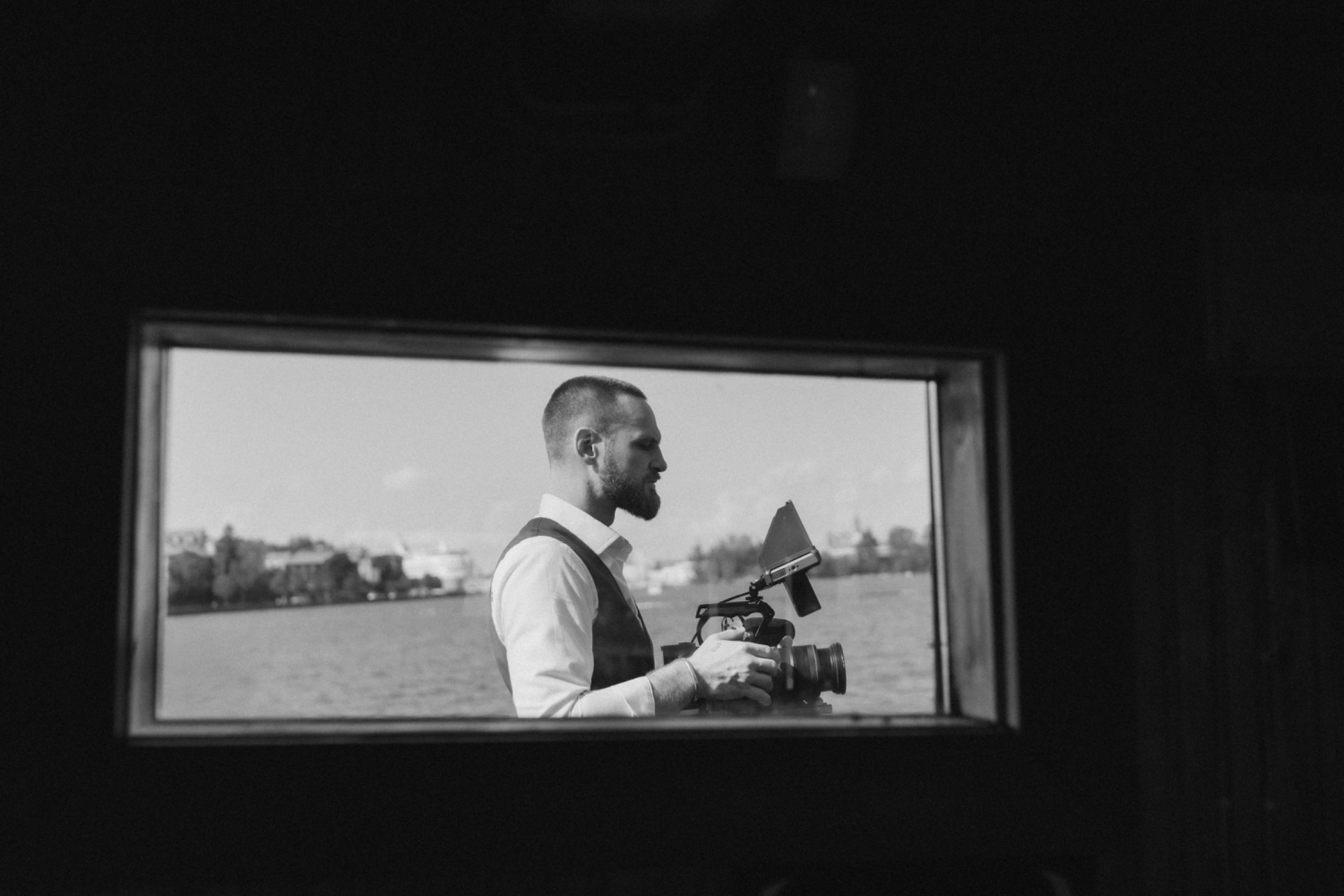 Bastian filming through a window aboard a ship in Helsinki